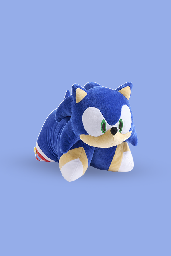 Plush toy of a blue character with white face and red shoes on a light blue background