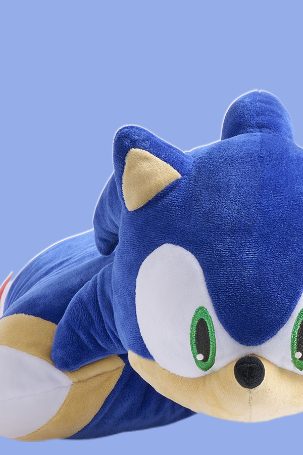 Plush toy of a blue character with a white face and green eyes on a light blue background