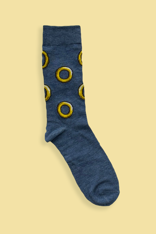 Blue sock with yellow circular patterns on a beige background