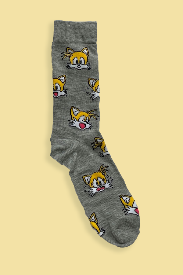 Gray sock with cartoon fox pattern on a beige background
