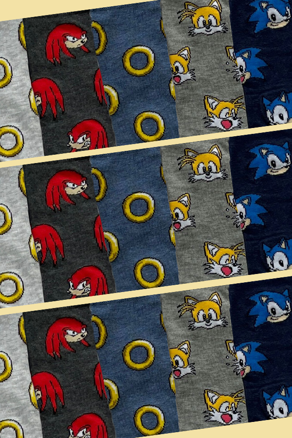 Patterned fabric with cartoon character faces and rings on a checkered background